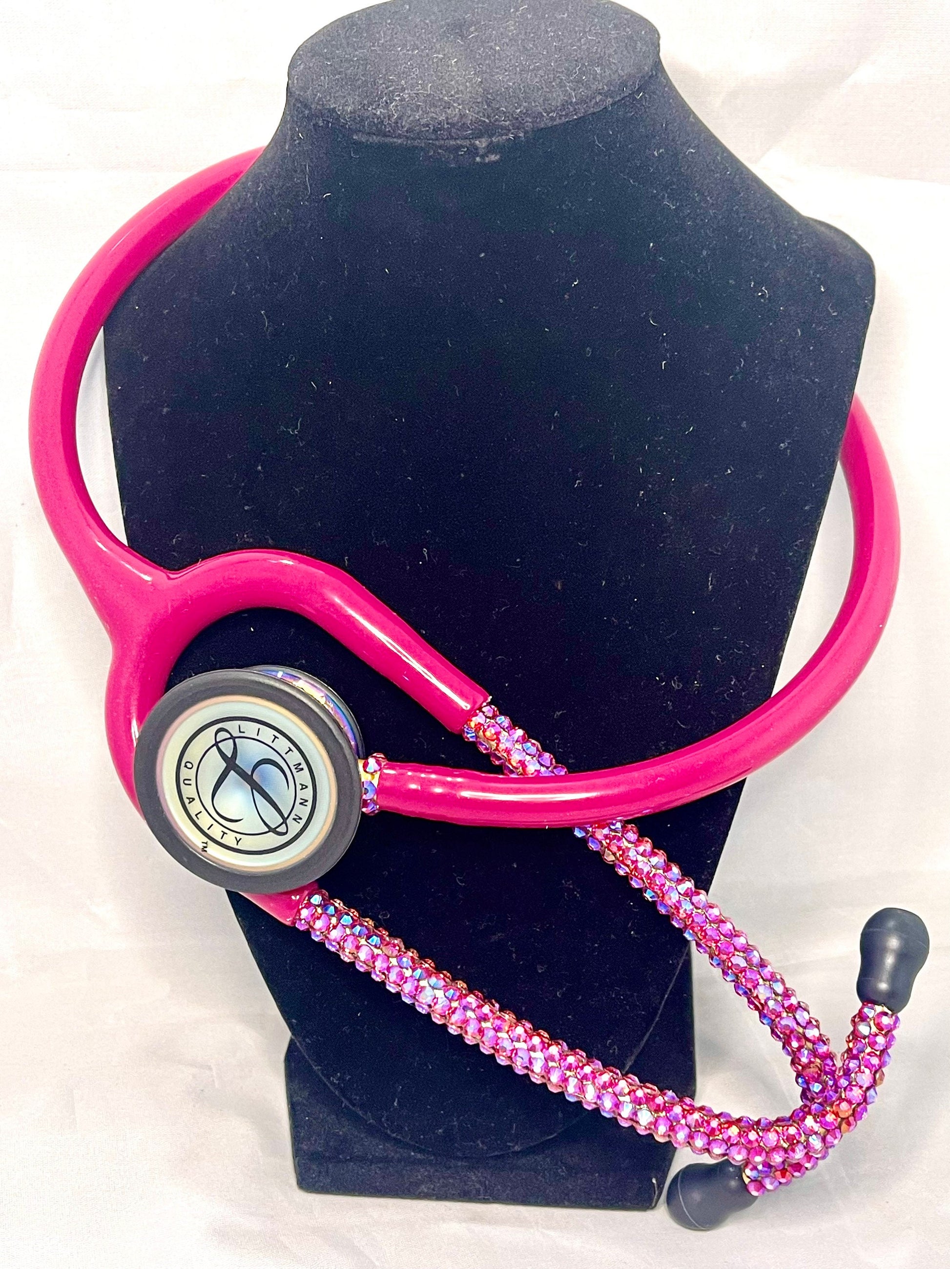 Cotton Candy Littmann Classic III Stethoscope, Rainbow Finish, Raspberry color tubing, individually placed Iridescent rhinestones on the chest piece and headset designed by Blingbykey. See other listings for matching custom protection hard case.