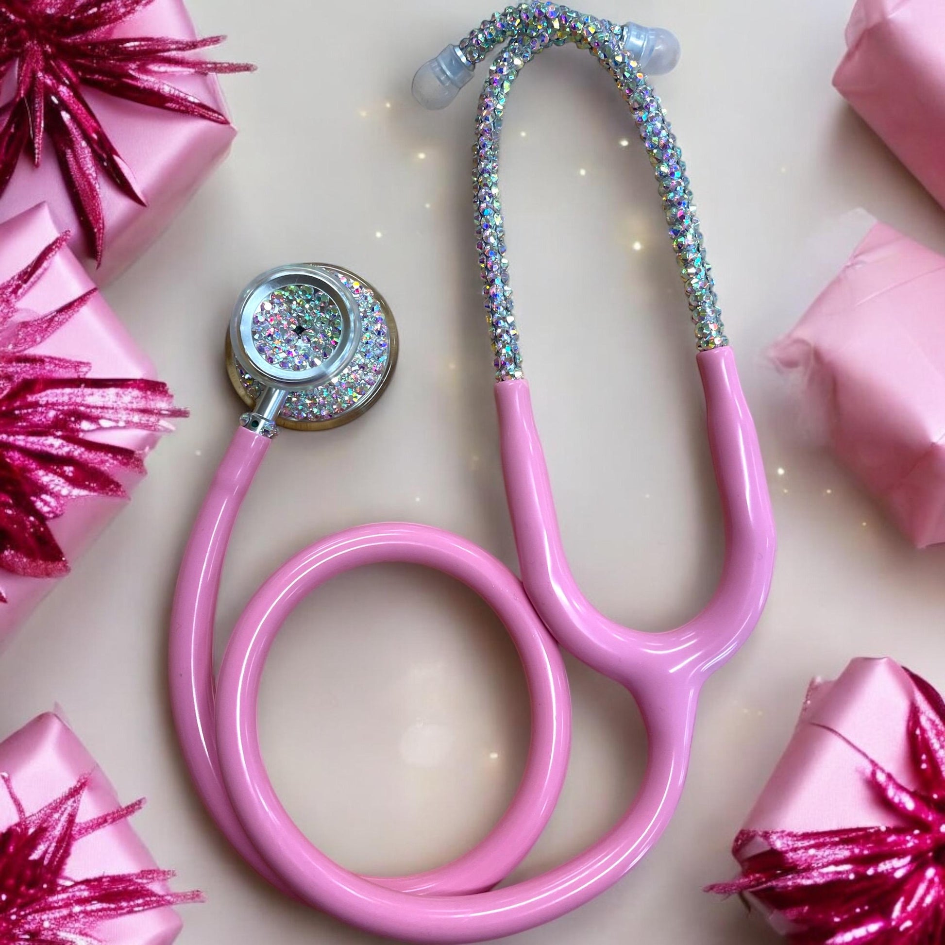 Self-Love Bling Stethoscope

This unique, handmade stethoscope features high-quality, sparkly golden iridescent rhinestones that exhibit luminous colors when viewed from various angles. Each rhinestone is individually hand-placed on a pastel pink MDF Acoustica stethoscope, ensuring both aesthetic appeal and exceptional craftsmanship.