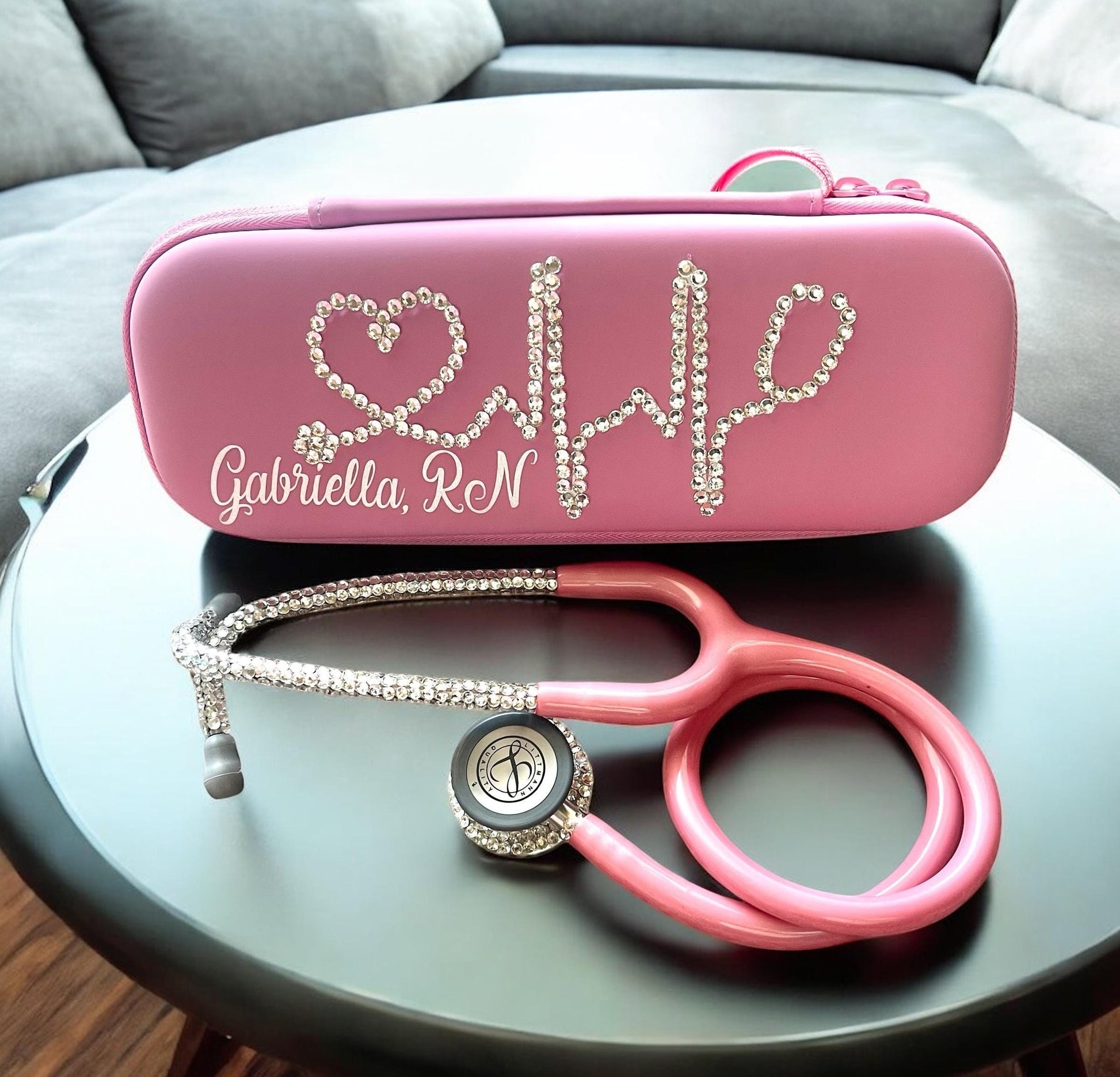 Inner Peace Pink Littmann Classic III Stethoscope, Pearl Pink color tubing, individually placed clear rhinestones on the chest piece and headset, with matching protection hard case and personalized name in shimmering silver font. (sold separately)