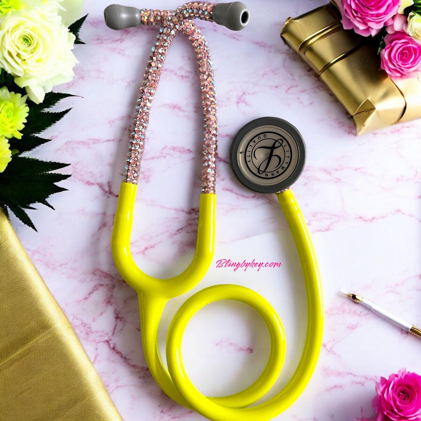 Ray of Sunshine Littmann Stethoscope! A fabulous creation by Blingbykey, designed exclusively for healthcare heroes who want to bring a splash of joy and sparkle to their everyday lives! This eye-catching Littmann Classic III boasts a vibrant Lemon Lime yellow finish that radiates positivity and adorned with exquisite, hand-placed pink Preciosa crystals on the headset and chest piece, adding an extra touch of glamour to your medical toolkit.