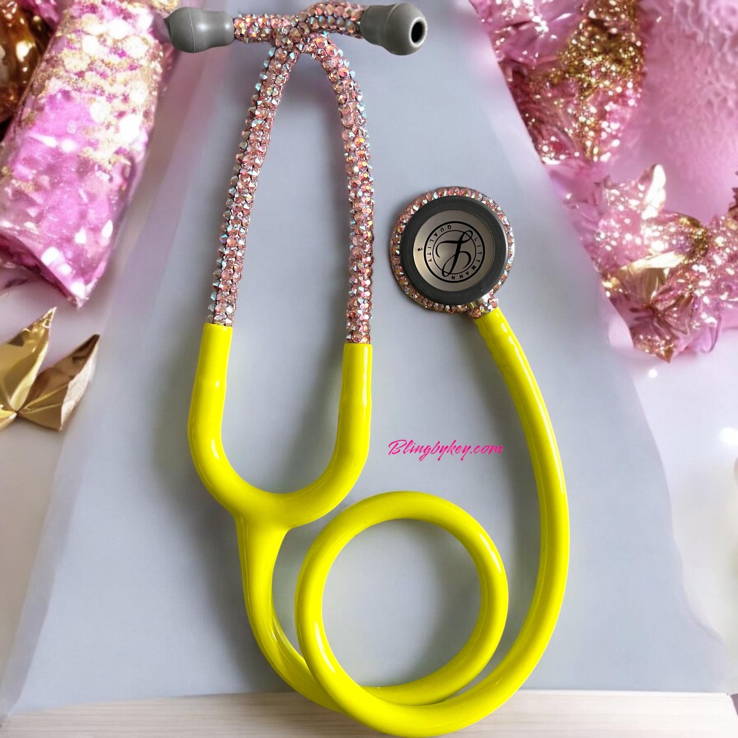 5839 3M Littmann Classic III Stethoscope Lemon—an eye-catching masterpiece brought to you by Blingbykey, crafted for healthcare professionals who want to infuse a little joy and sparkle into their daily routine! This stunning Littmann Classic III Stethoscope boasts a vibrant Lemon Lime yellow finish, beautifully adorned with handcrafted pink Preciosa crystals on both the headset and chest piece. Embrace your style while making a difference—because who says you can’t shine while you heal?